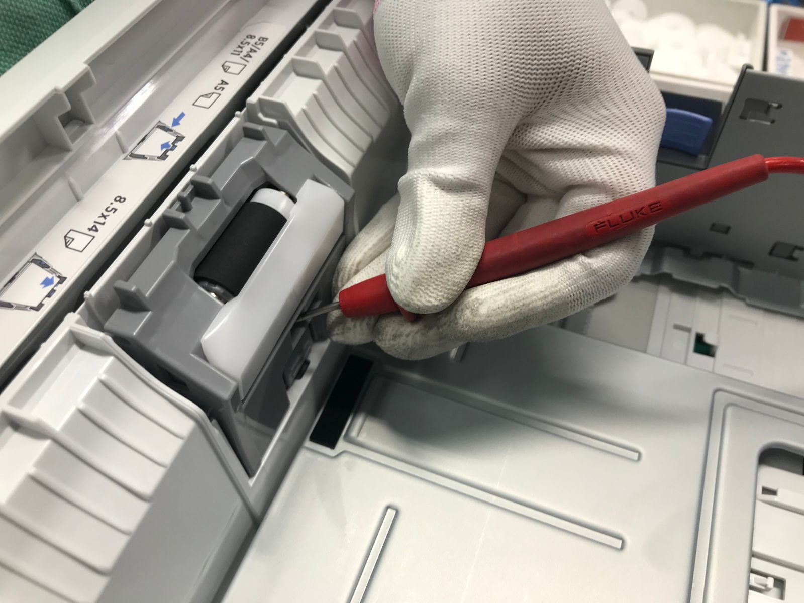 Technicien effectuant la maintenance d'une imprimante de bureau